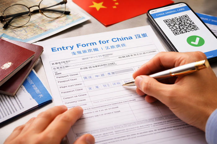 China entry form completed with passport and QR code on smartphone